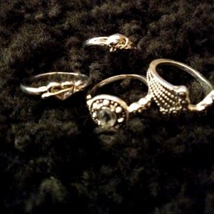 Four beautiful silver tone fashion rings for $5.00